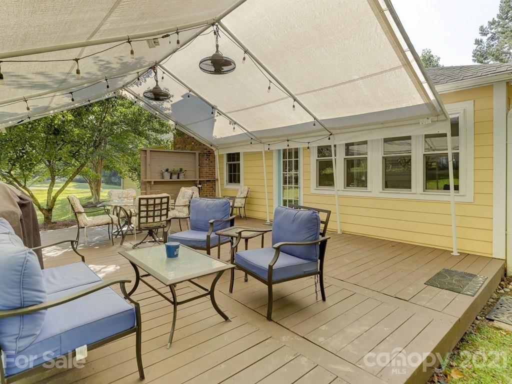 1520 Cobblestone Court Fort Mill, SC 29708 - Photo 39 of 47 a view of a patio with table and chairs with wooden floor and fence