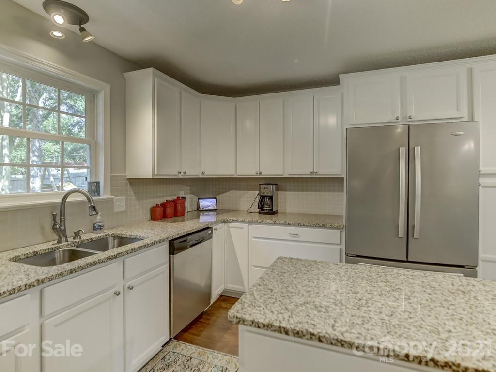 1520 Cobblestone Court Fort Mill, SC 29708 - Photo 10 of 47 a kitchen with granite countertop a refrigerator sink and cabinets