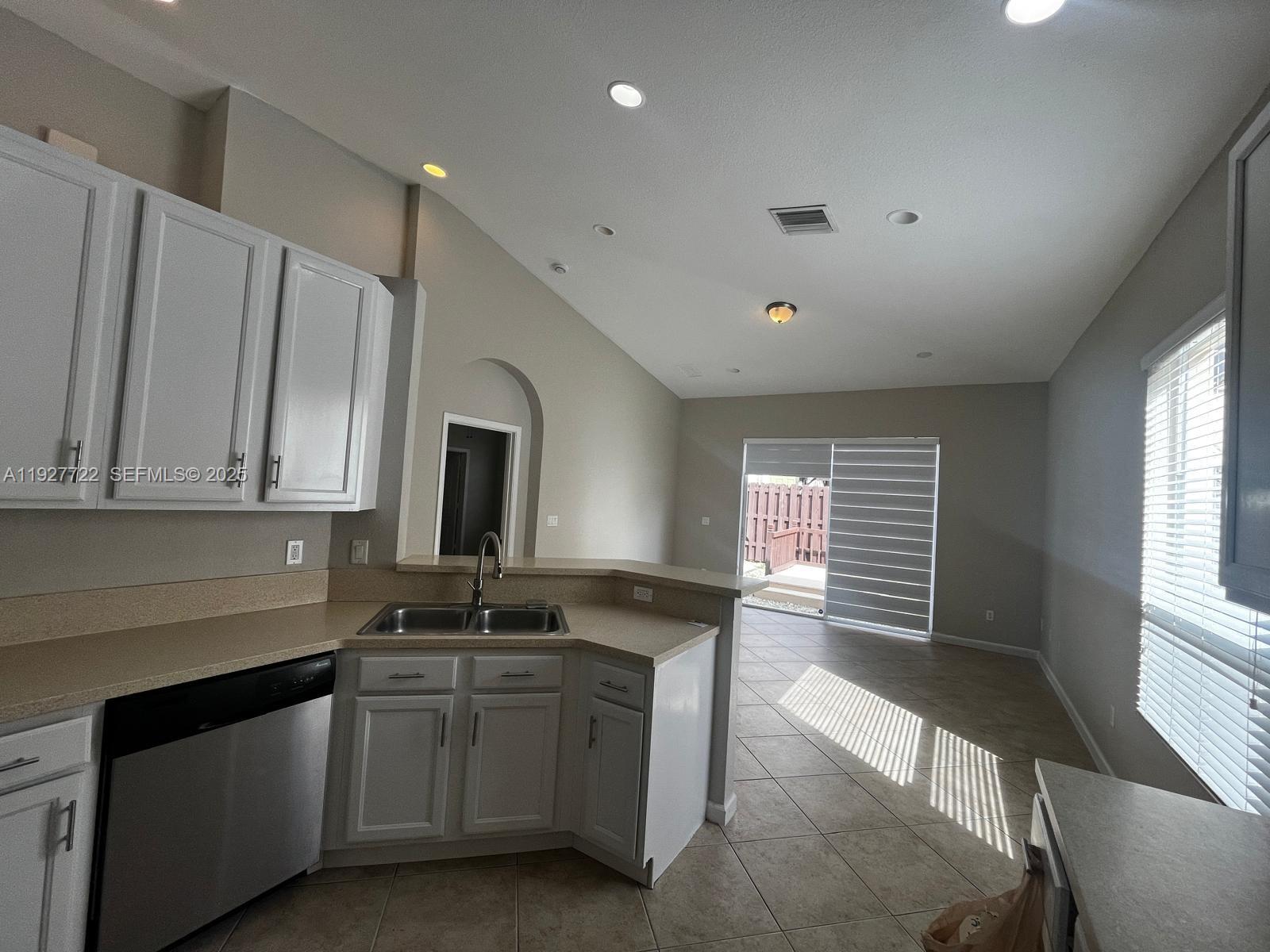 2219 Portofino Avenue Homestead, FL 33033 - Photo 5 of 9 a kitchen with granite countertop a stove a sink and a microwave