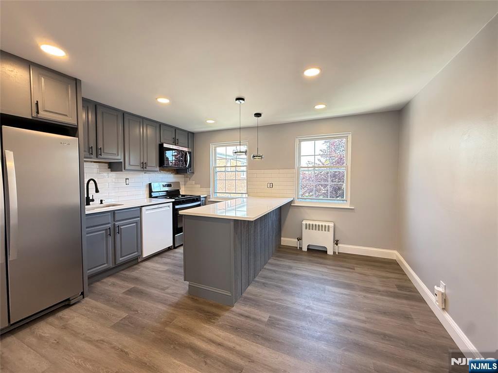 20 Clark Court Rutherford, NJ 07070 - Photo 14 of 29 a kitchen with a refrigerator and a stove top oven