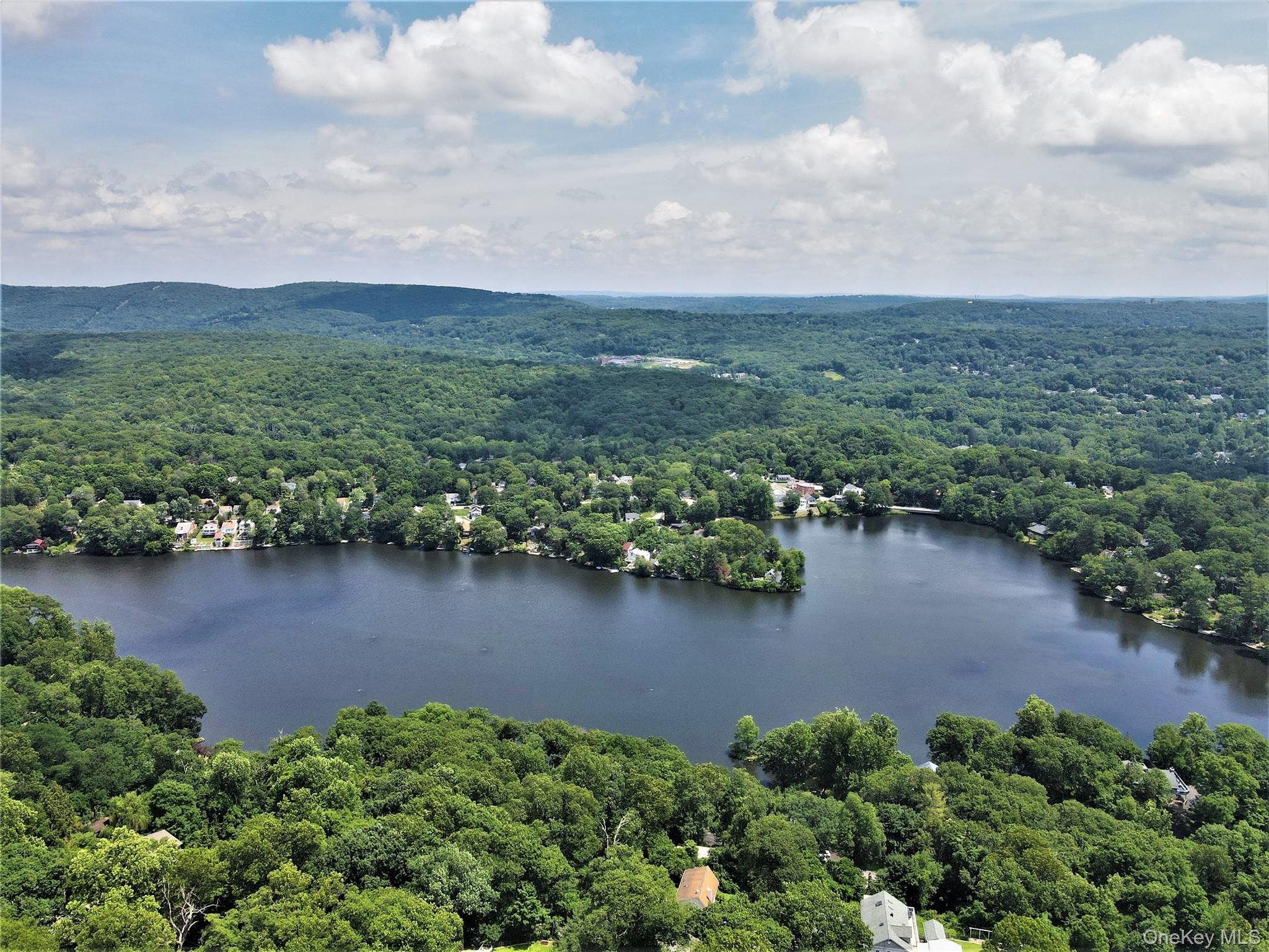 an aerial view of a houses with ocean view