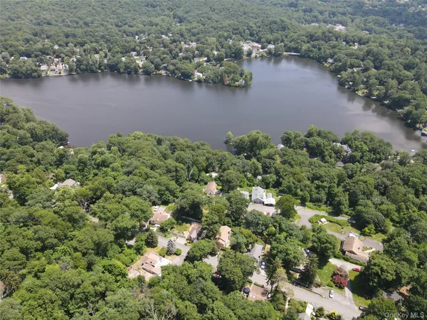 an aerial view of a houses with a lake view