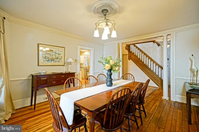 a view of a dining room with furniture wooden floor and chandelier