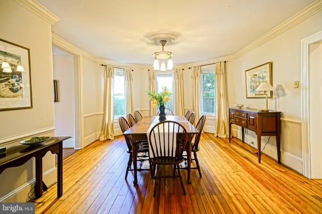 a kitchen with a table chairs stove and cabinets