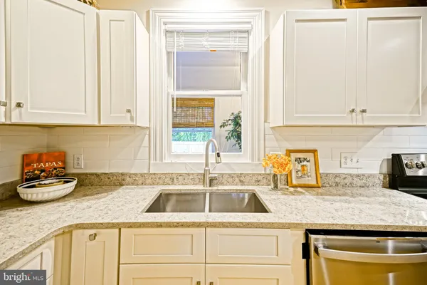 a kitchen with a table chairs refrigerator and cabinets