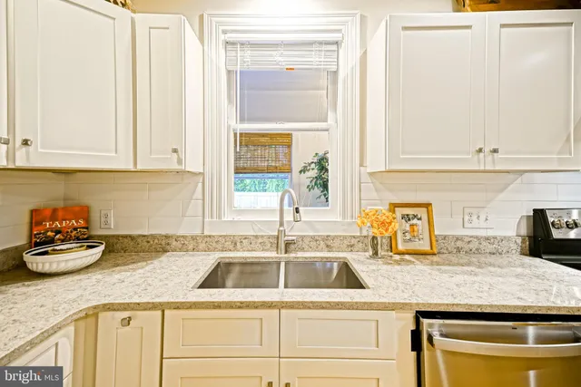 a kitchen with a table chairs refrigerator and cabinets