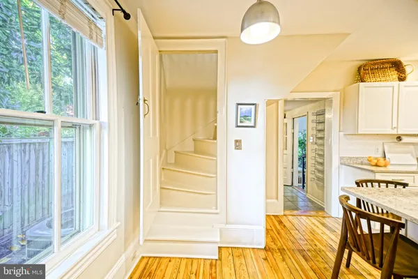 a living room with furniture a piano and a window
