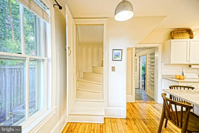 a living room with furniture a piano and a window