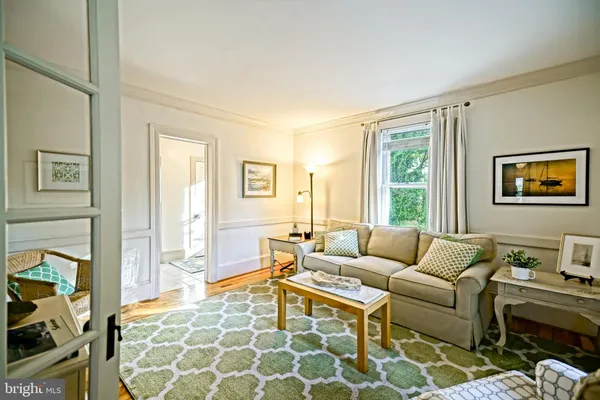 a bedroom with a bed and dresser with mirror