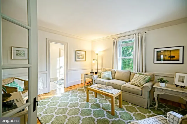 a bedroom with a bed and dresser with mirror