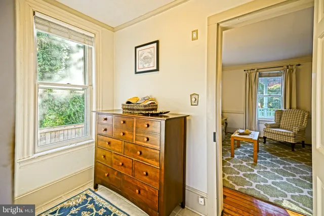 a bedroom with furniture and a window