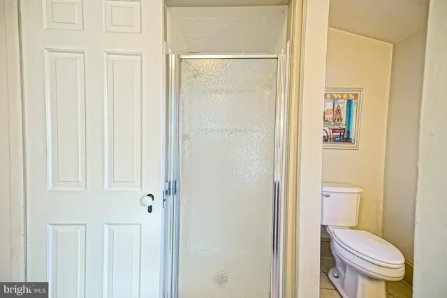 a bathroom with a sink toilet vanity and shower