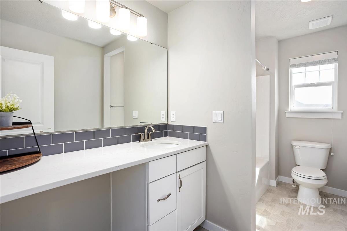 3729 South Maple Ridge Avenue Nampa, ID 83686 - Photo 33 of 46 Bathroom featuring vanity and washtub / shower combination