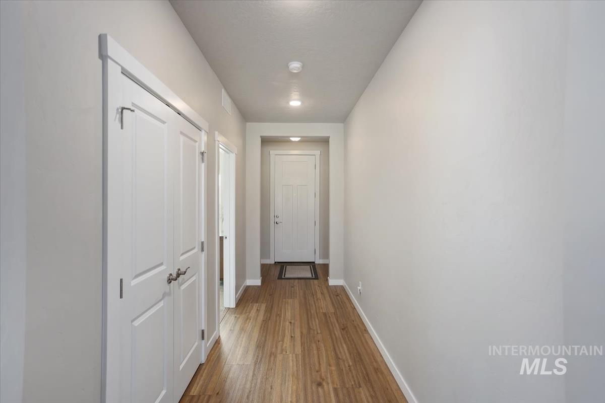 3729 South Maple Ridge Avenue Nampa, ID 83686 - Photo 4 of 46 Hallway featuring baseboards and wood finished floors