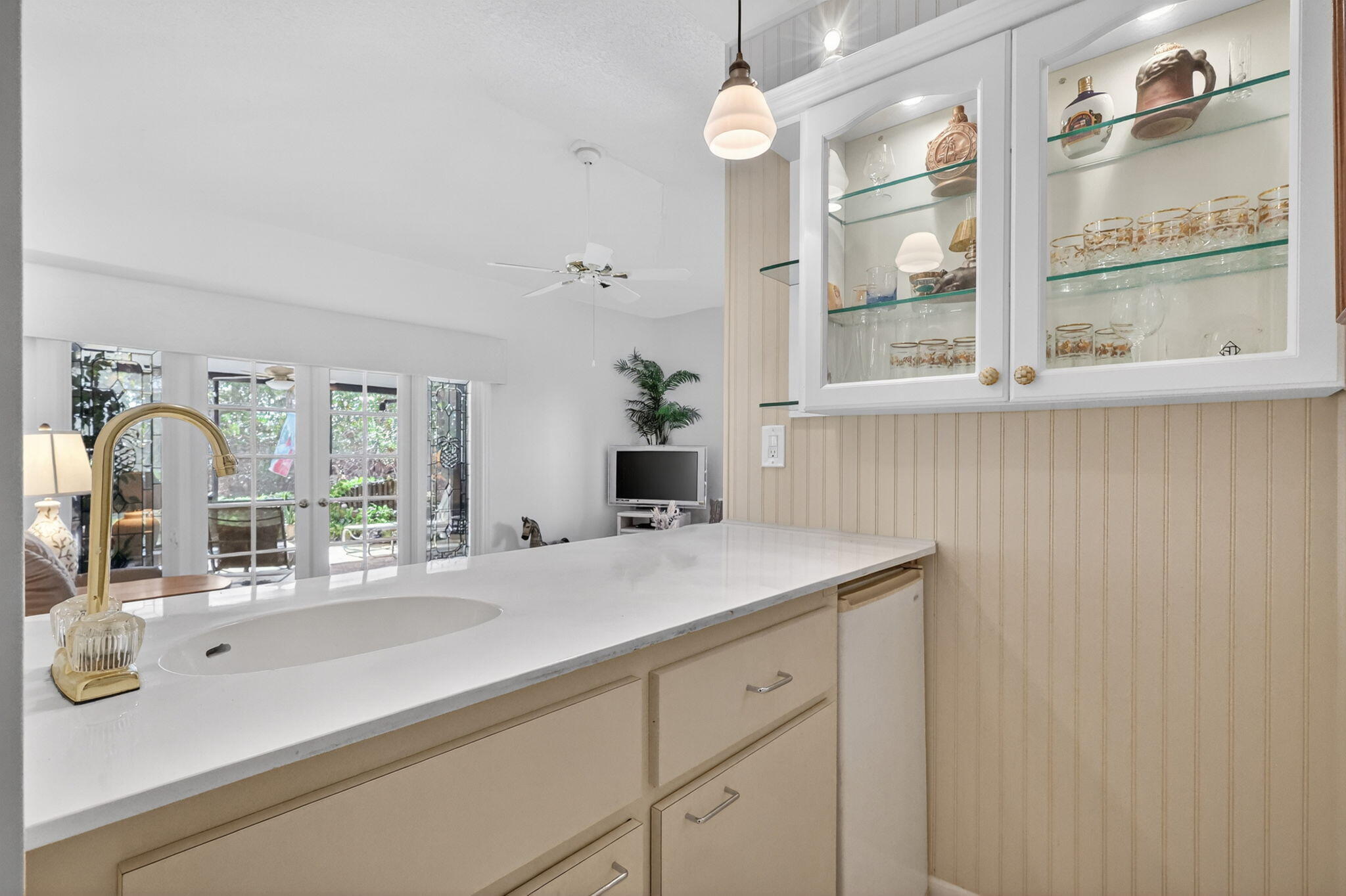 5422 Southeast Meredith Terrace Stuart, FL 34997 - Photo 12 of 56 a bathroom with a sink and a large mirror next to a window