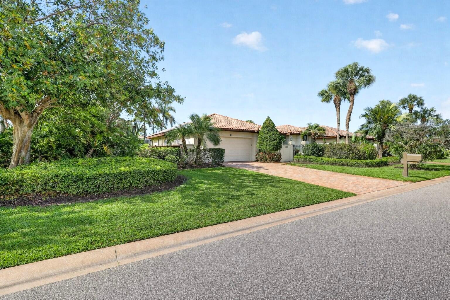 5422 Southeast Meredith Terrace Stuart, FL 34997 - Photo 2 of 56 a view of a house with a big yard and potted plants