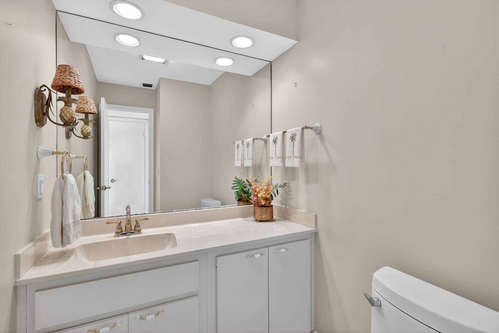 5422 Southeast Meredith Terrace Stuart, FL 34997 - Photo 21 of 56 a bathroom with a sink a toilet and a mirror