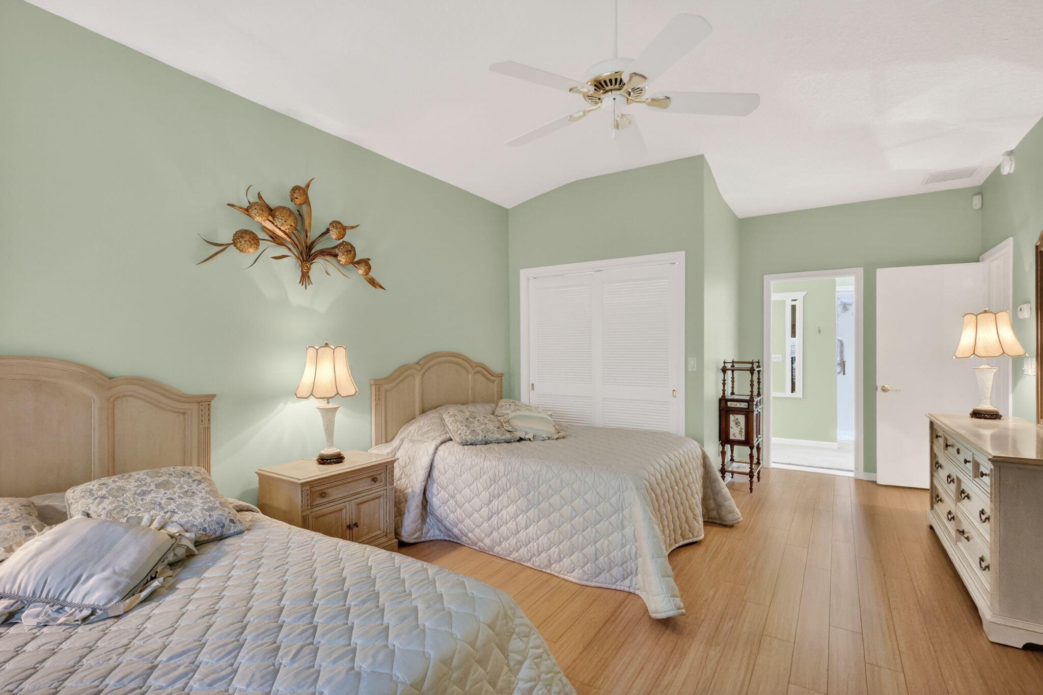 5422 Southeast Meredith Terrace Stuart, FL 34997 - Photo 22 of 56 a bedroom with a bed and a chandelier