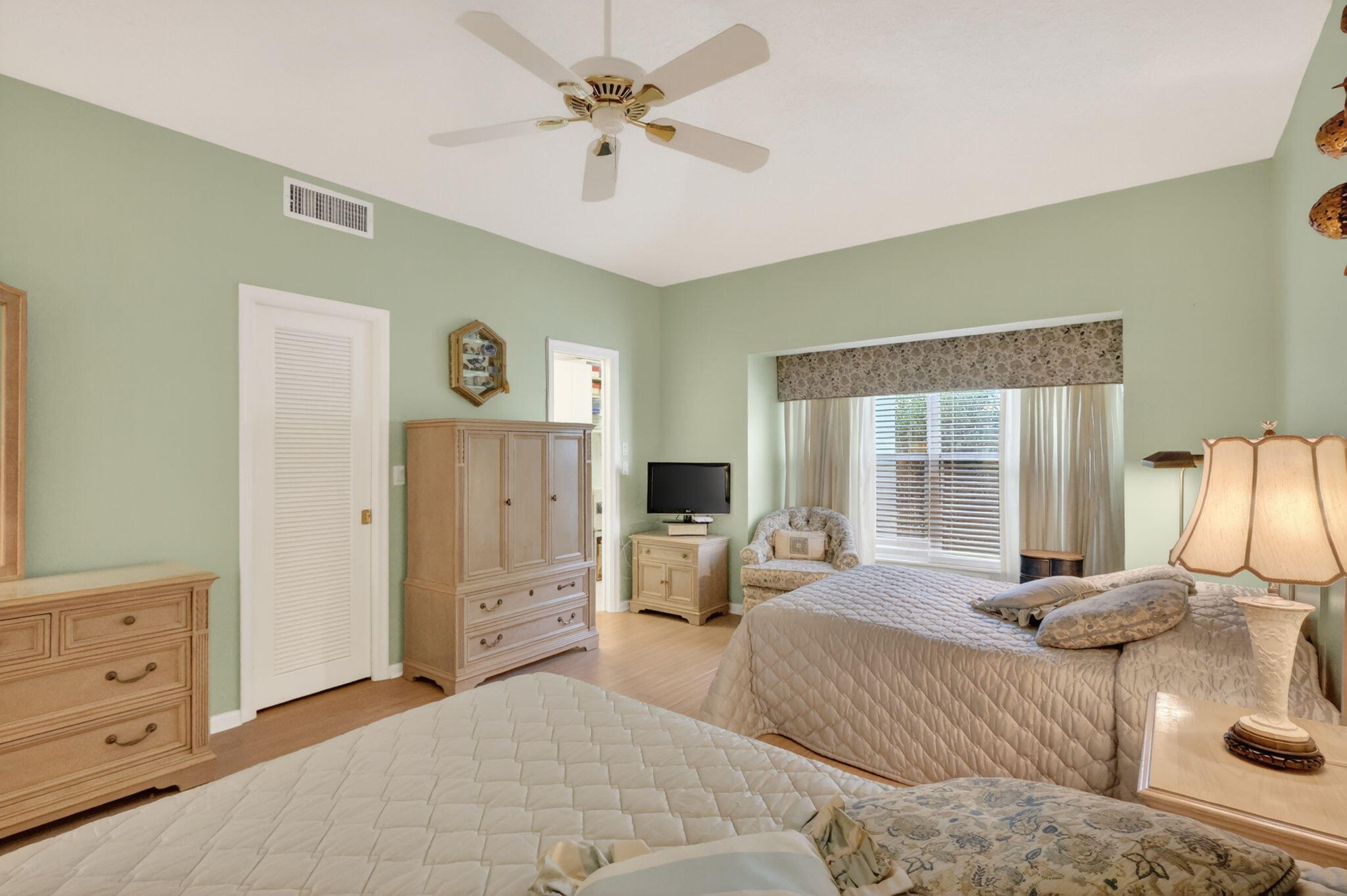 5422 Southeast Meredith Terrace Stuart, FL 34997 - Photo 24 of 56 a bedroom with a bed large window and couch