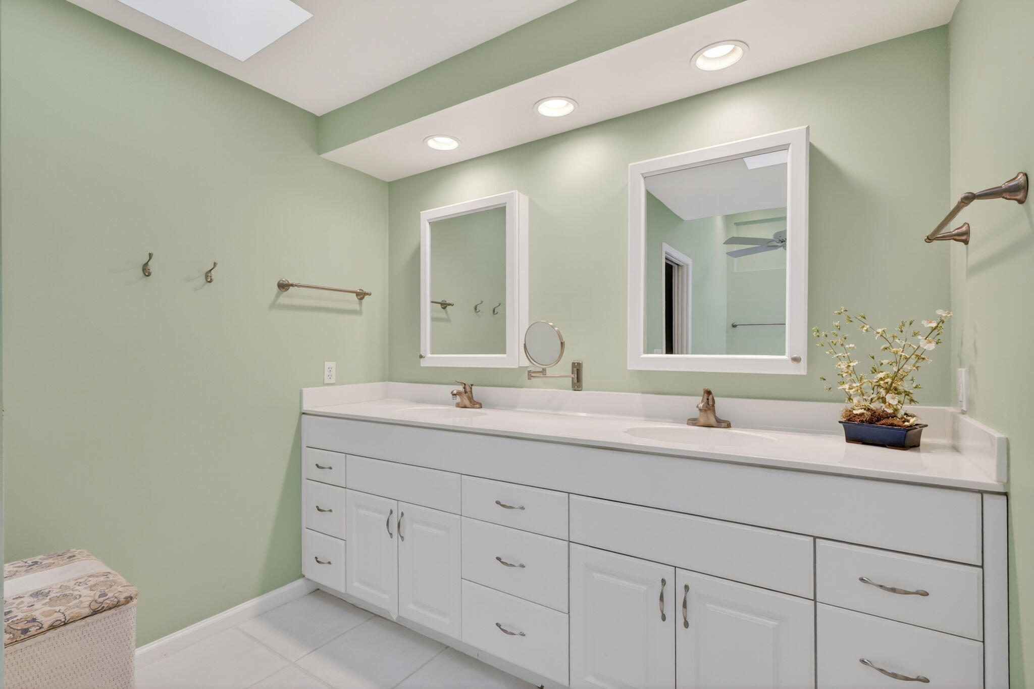 5422 Southeast Meredith Terrace Stuart, FL 34997 - Photo 25 of 56 a bathroom with a double vanity sink and a mirror