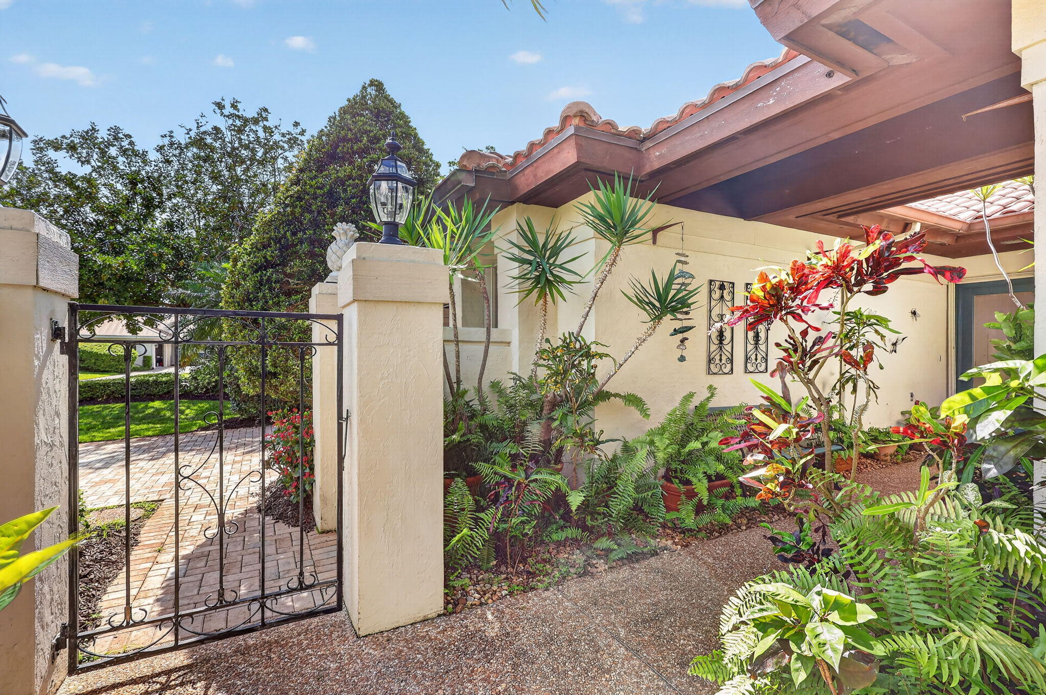 5422 Southeast Meredith Terrace Stuart, FL 34997 - Photo 4 of 56 a front view of a house with a yard and fountain