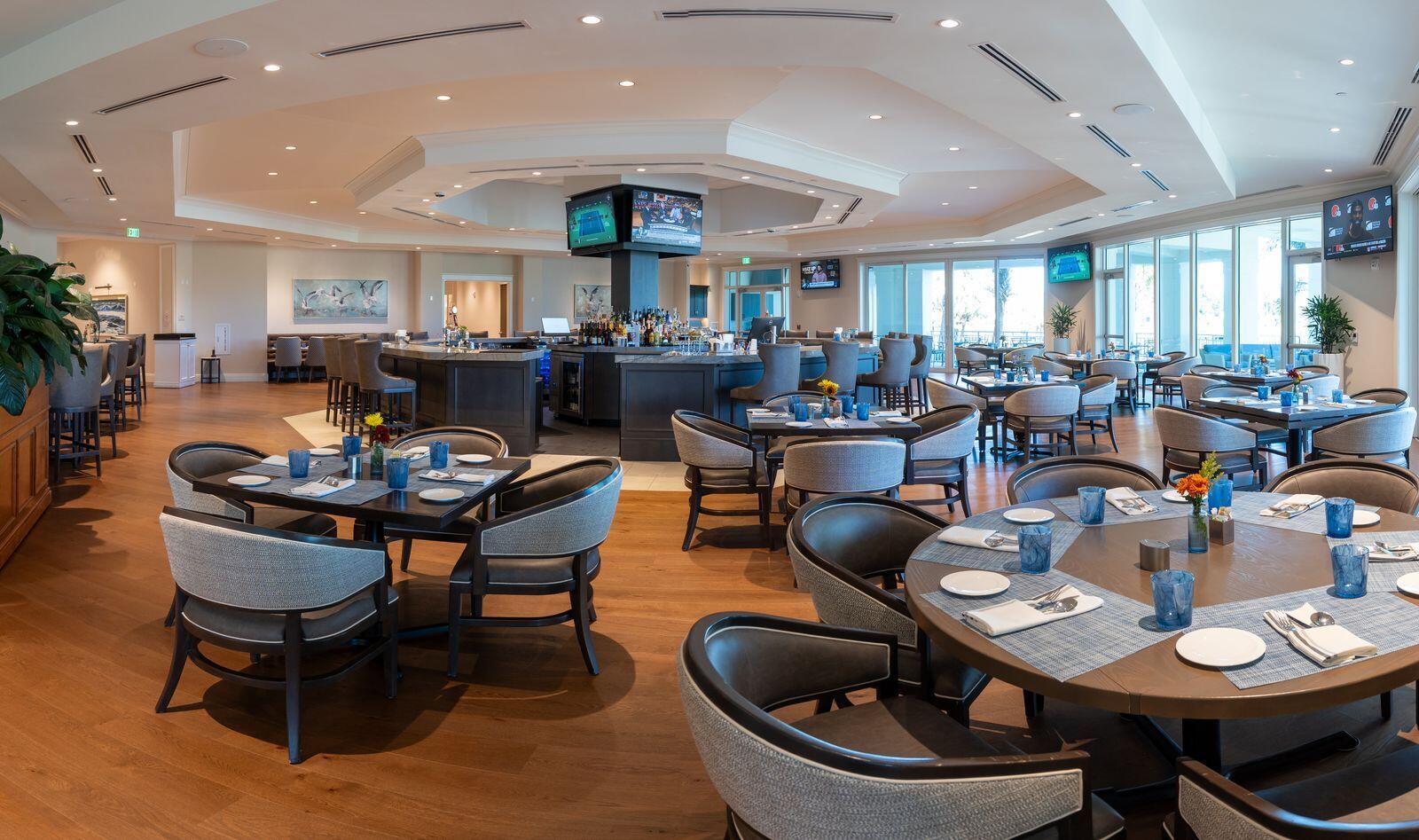 5422 Southeast Meredith Terrace Stuart, FL 34997 - Photo 46 of 56 a living room with furniture a chandelier and a dining table