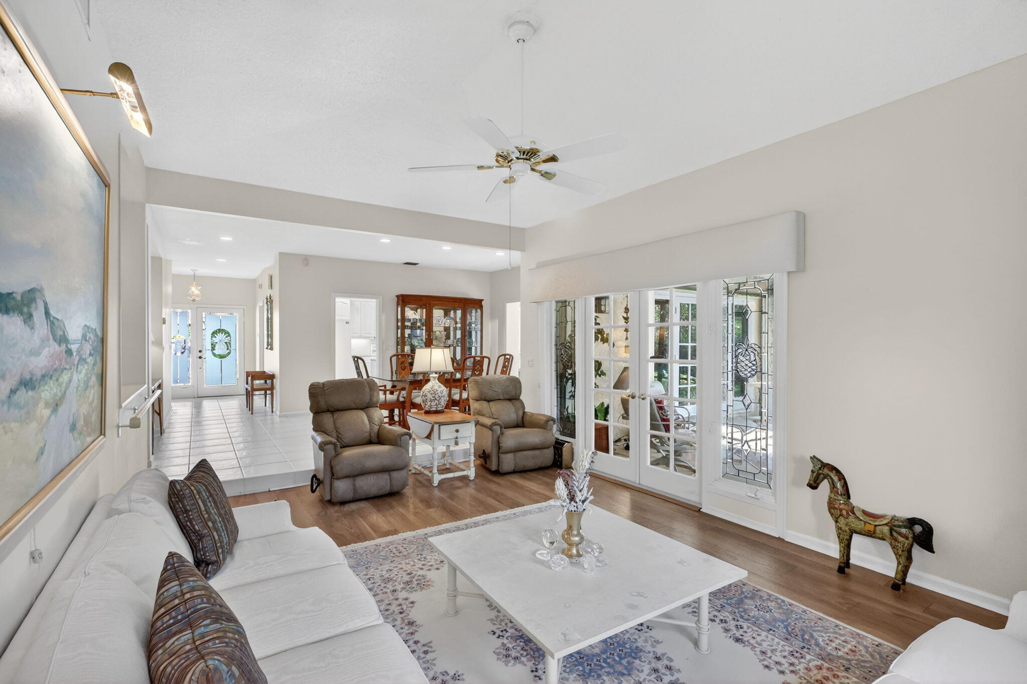 5422 Southeast Meredith Terrace Stuart, FL 34997 - Photo 9 of 56 a living room with furniture a table and wooden floor