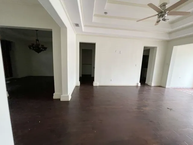 a view of a livingroom with wooden floor and a ceiling fan