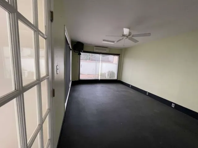 a view of room with window and a ceiling fan