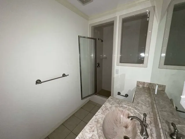 a bedroom with a bed and a mirror