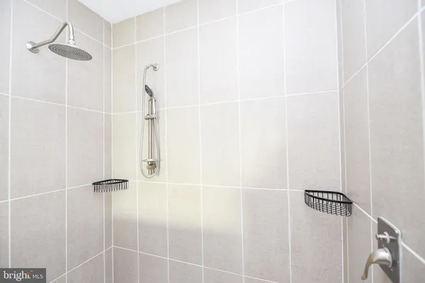 a bathroom with double vanity sink and a mirror