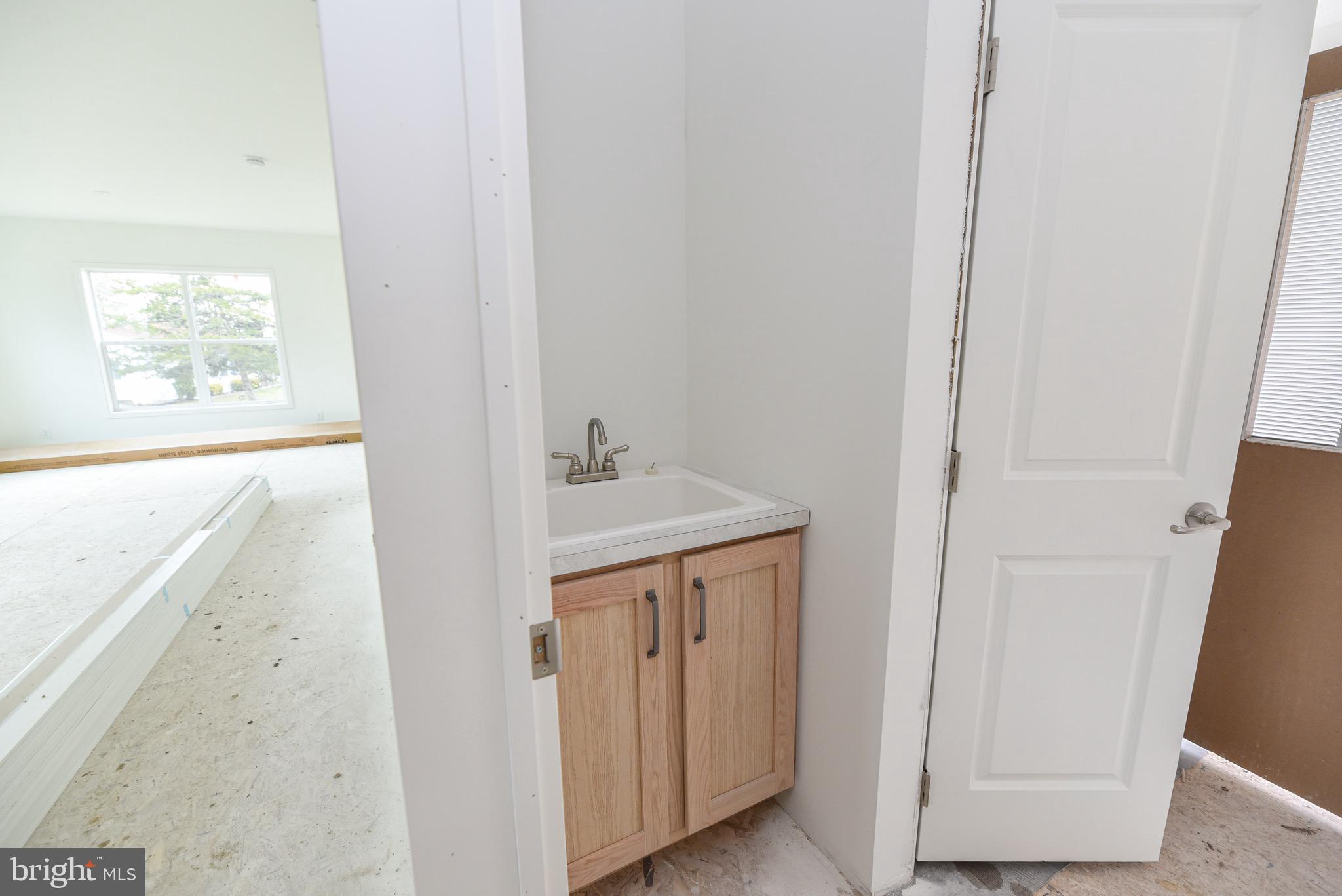 34340 River Road, Unit 129 Long Neck, DE 19966 - Photo 13 of 16 a bathroom with a sink and a mirror