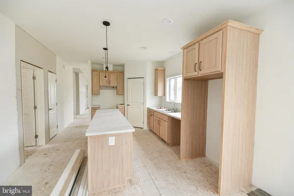 a bathroom with granite countertop a sink a toilet and shower