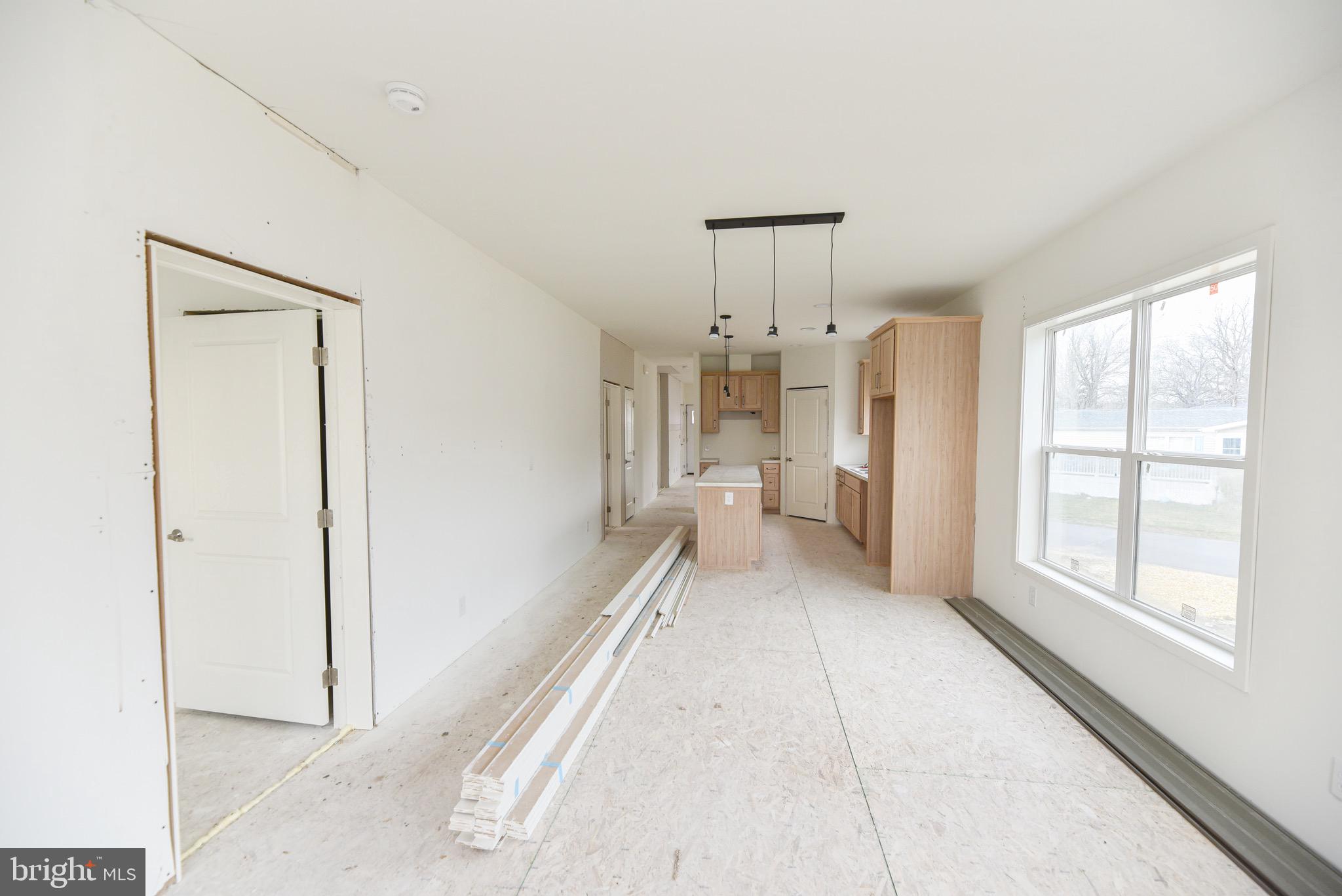 34340 River Road, Unit 129 Long Neck, DE 19966 - Photo 5 of 16 a room with a bed and a chandelier
