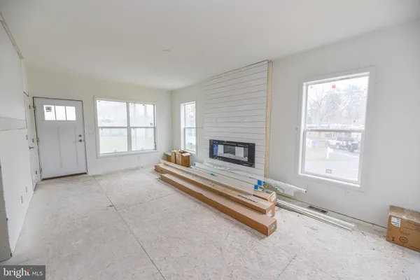 a living room with a fireplace and windows