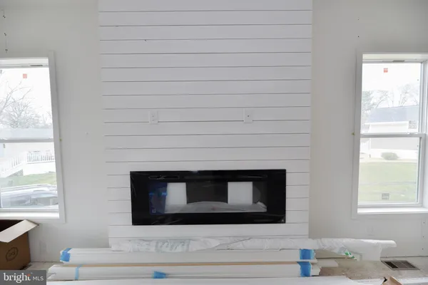 a view of a livingroom with an empty space and a fireplace