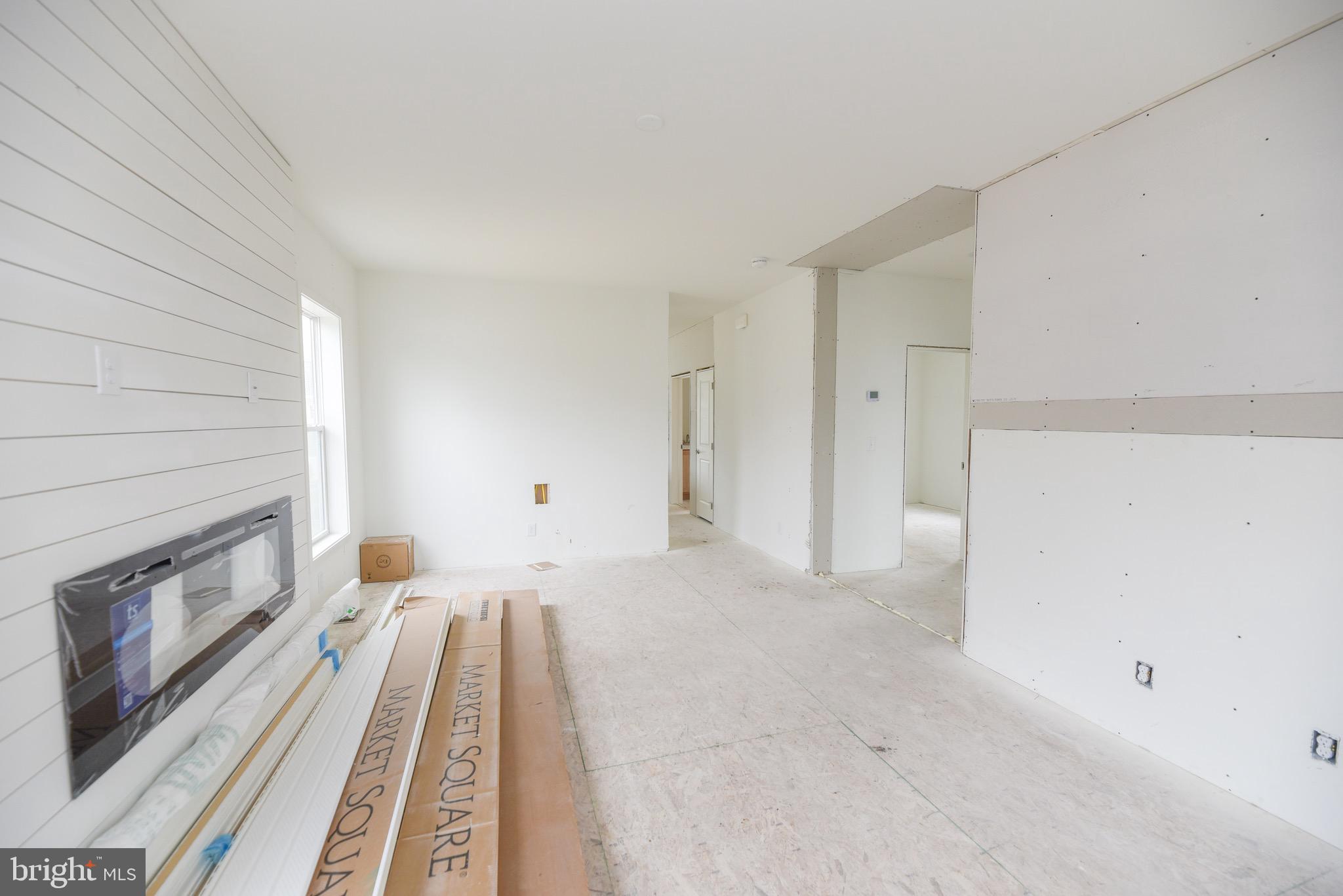 34340 River Road, Unit 129 Long Neck, DE 19966 - Photo 9 of 16 a view of a livingroom with an empty space and a fireplace