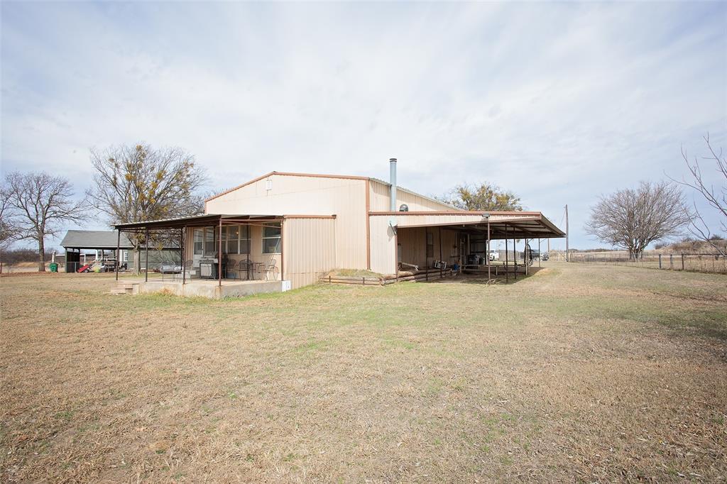 1193 Eastside Lake Road Graham, TX 76450 - Photo 14 of 38 a front view of a house with a yard and garage