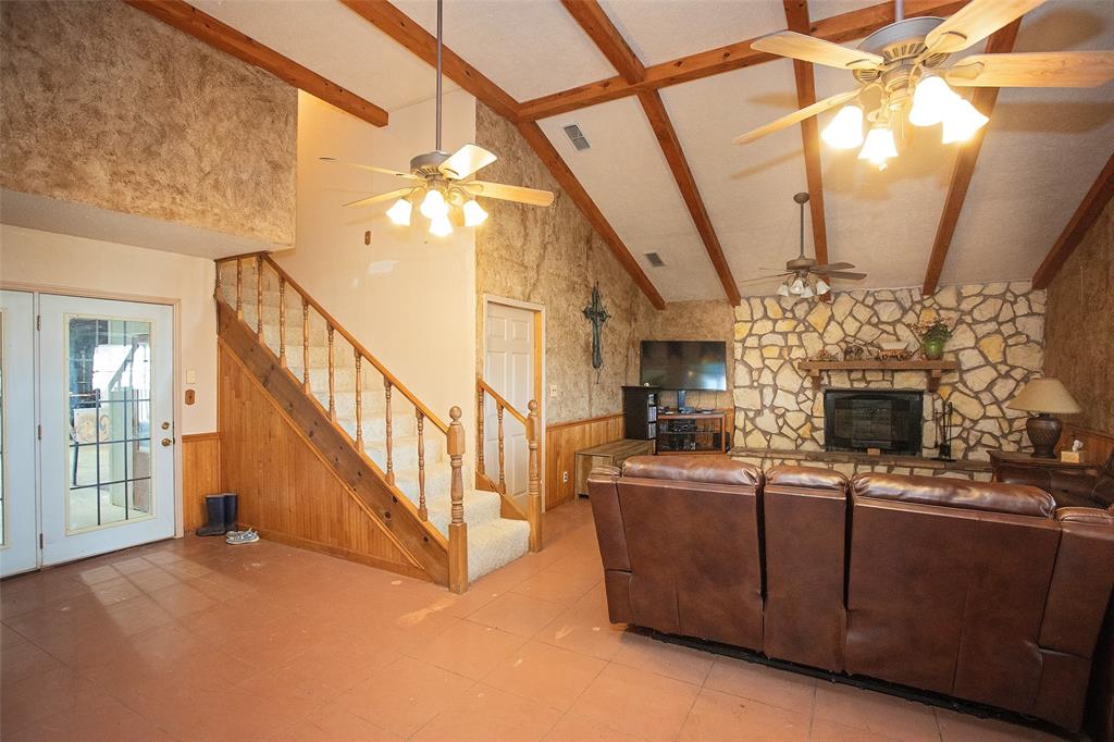 1193 Eastside Lake Road Graham, TX 76450 - Photo 23 of 38 a view of a livingroom with furniture staircase and kitchen view