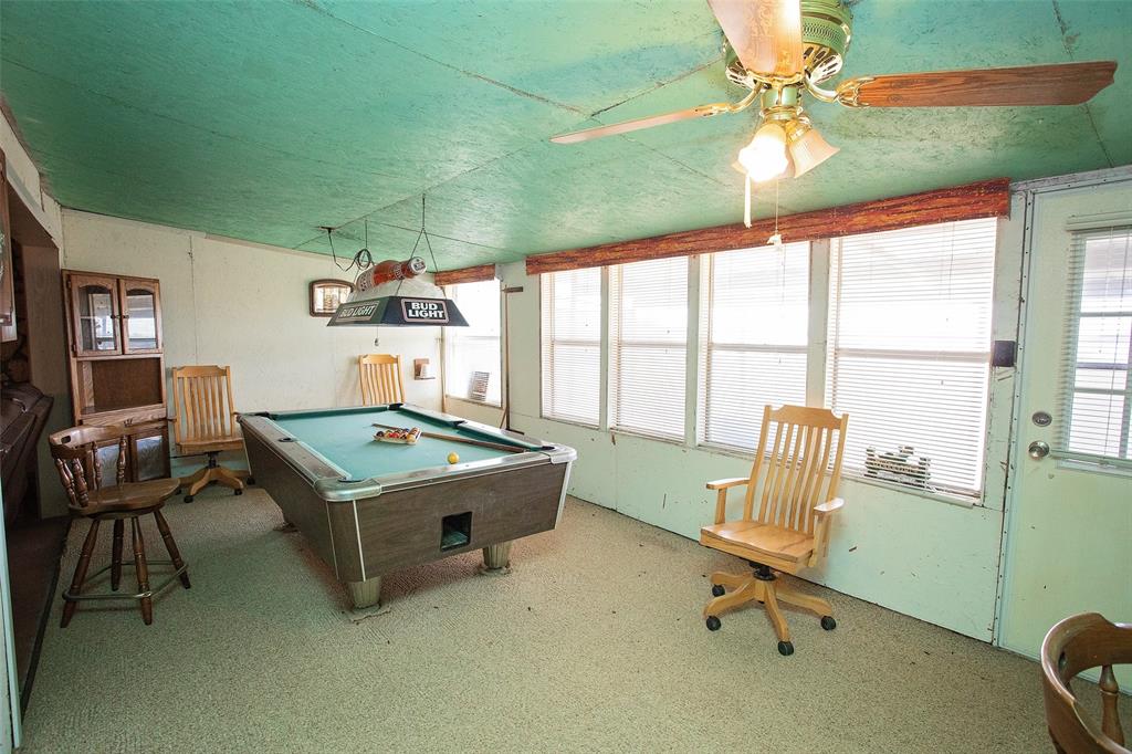1193 Eastside Lake Road Graham, TX 76450 - Photo 25 of 38 a living room with furniture a fireplace and a large window