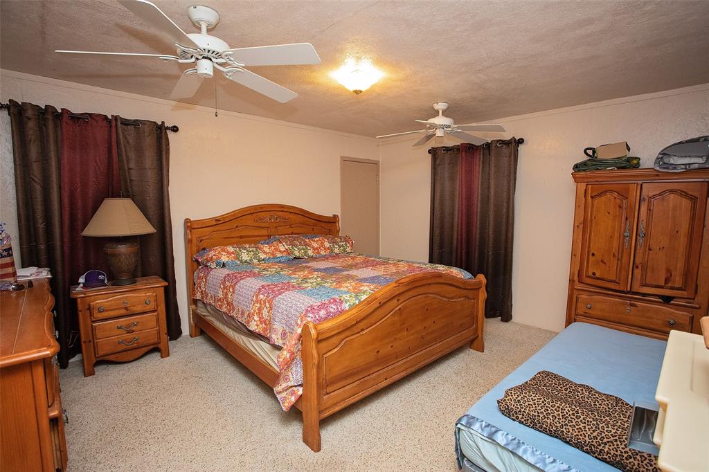 1193 Eastside Lake Road Graham, TX 76450 - Photo 29 of 38 a bedroom with a bed dresser and a window