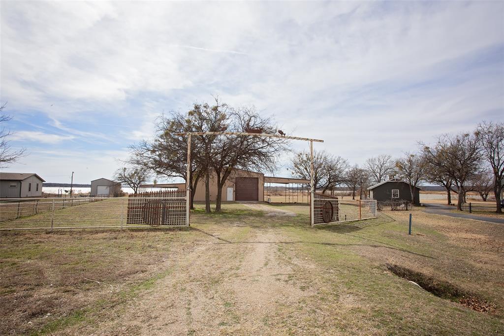 1193 Eastside Lake Road Graham, TX 76450 - Photo 30 of 38 a view of a yard with wooden fence