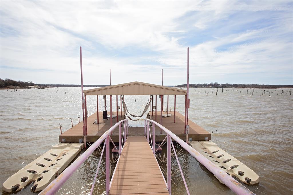 1193 Eastside Lake Road Graham, TX 76450 - Photo 10 of 38 a view of a balcony with wooden floor and fence
