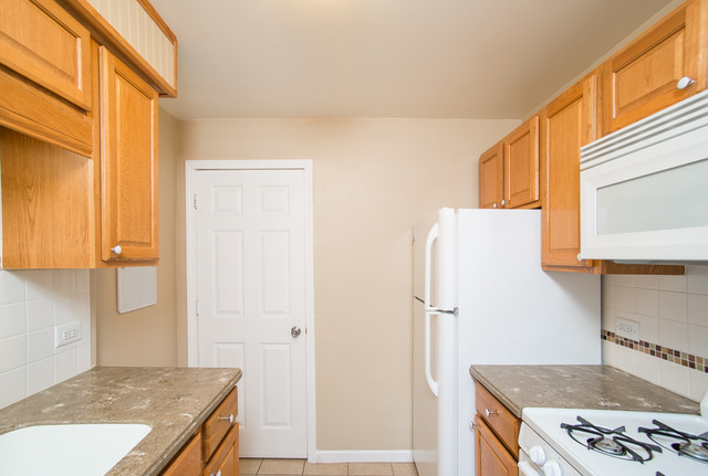 263-265 Chicago Road Oswego, IL 60543 - Photo 11 of 25 a kitchen with a stove and a refrigerator