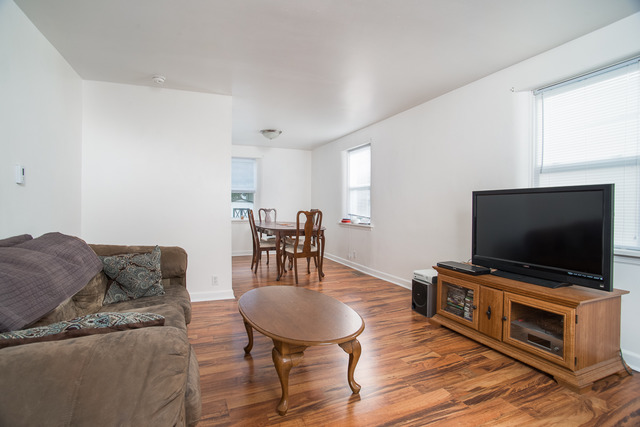 263-265 Chicago Road Oswego, IL 60543 - Photo 5 of 25 a living room with furniture and a flat screen tv