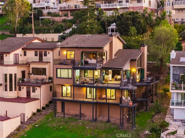a view of a house with a large window and potted plants