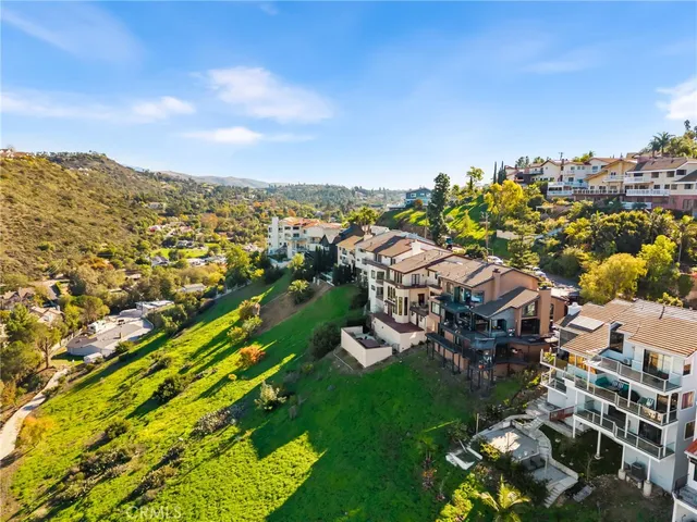 a view of a house with a garden and sitting area