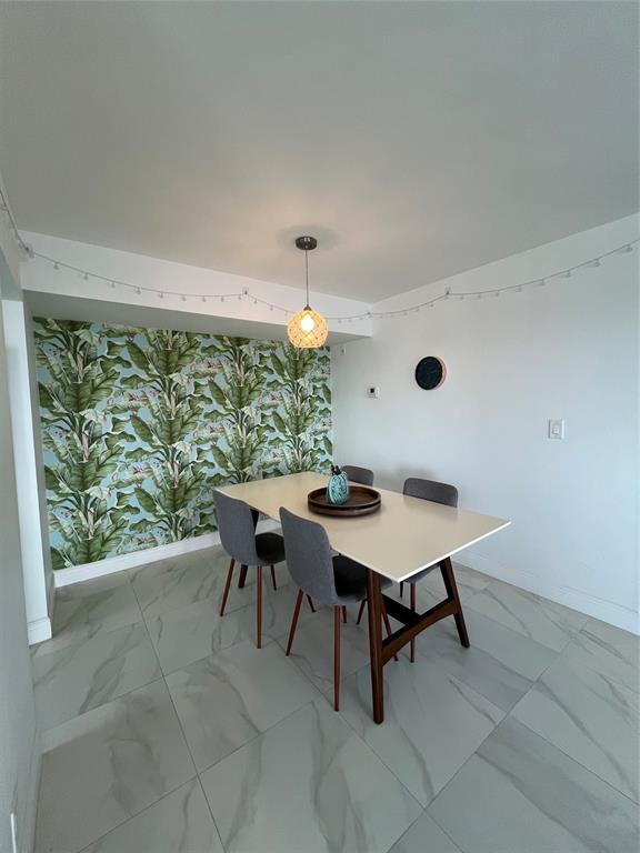 1200 Hibiscus Avenue, Unit 1501 Pompano Beach, FL 33062 - Photo 11 of 40 a table and chairs in a room