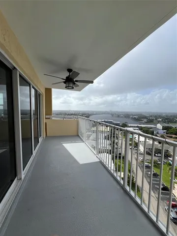a view of roof deck with wooden floor and fence