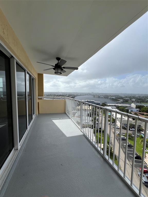 1200 Hibiscus Avenue, Unit 1501 Pompano Beach, FL 33062 - Photo 13 of 40 a view of roof deck with wooden floor and fence